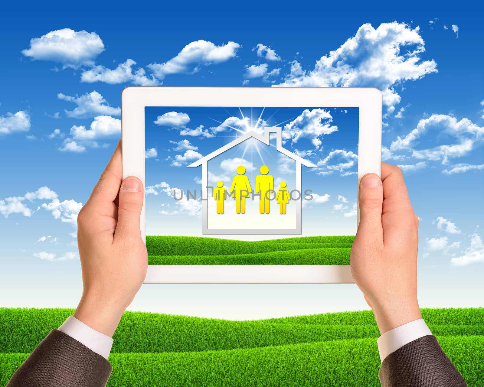 Hands holding tablet computer with the image of house and family icons. Nature landscape as backdrop