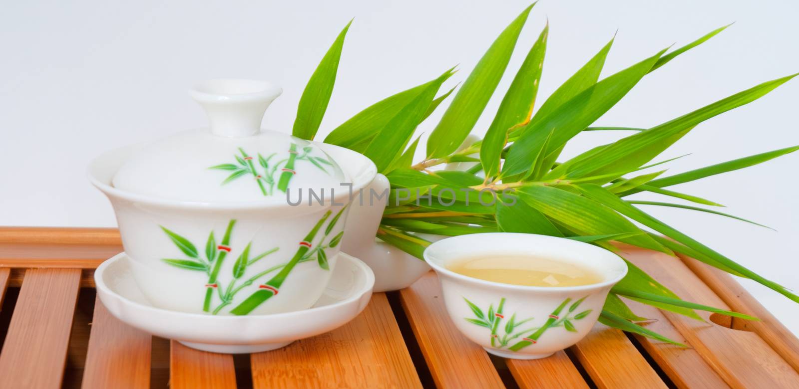 Chinese tea in teapot with cup isolated