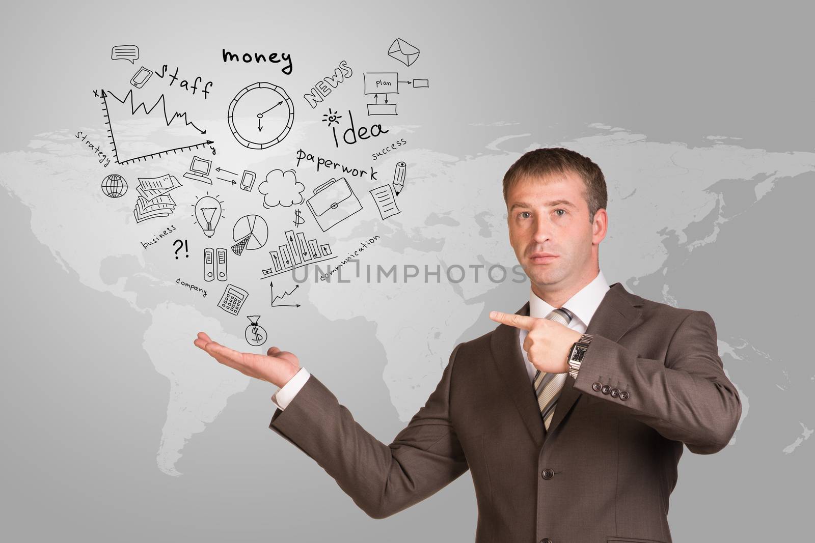 Businessman hold business sketches in hand. World map as backdrop