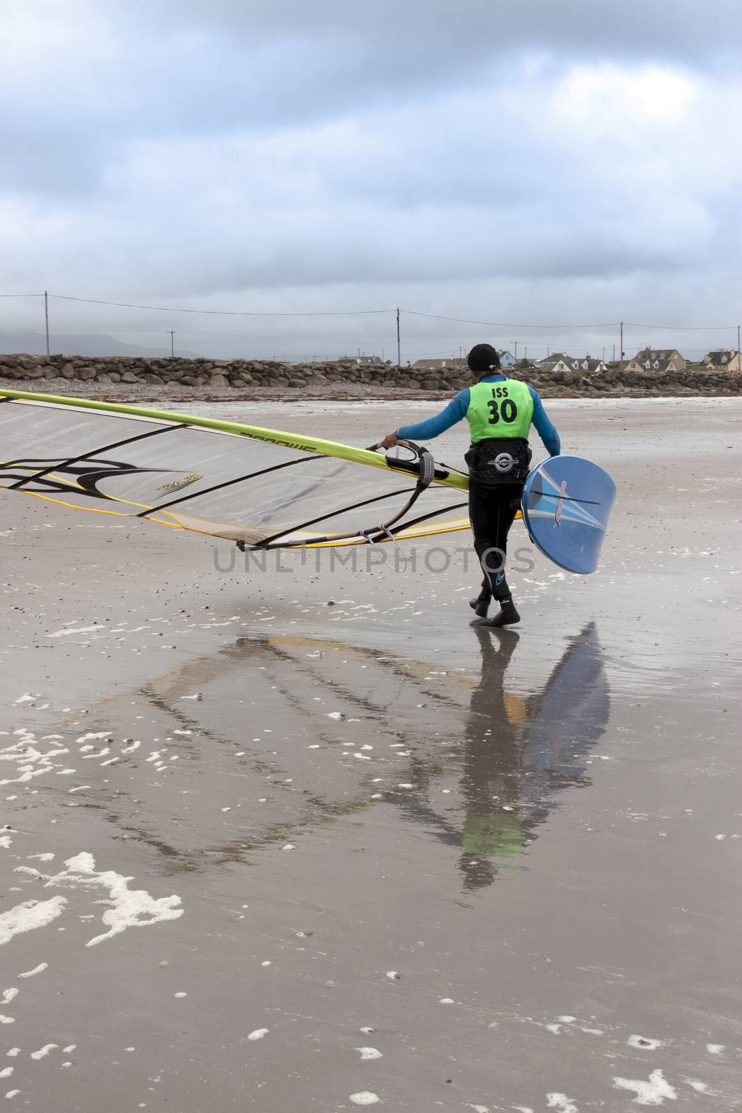 windsurfer finishing up after race and surf on the beach in the maharees county kerry ireland