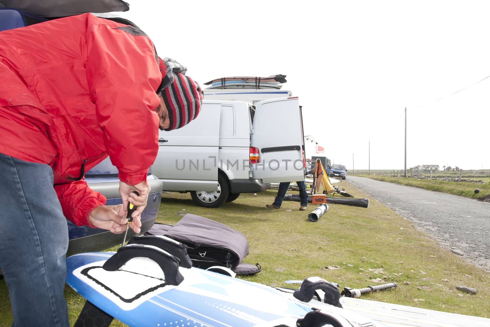 windsurfer getting equipment ready on the beach in the maharees county kerry ireland