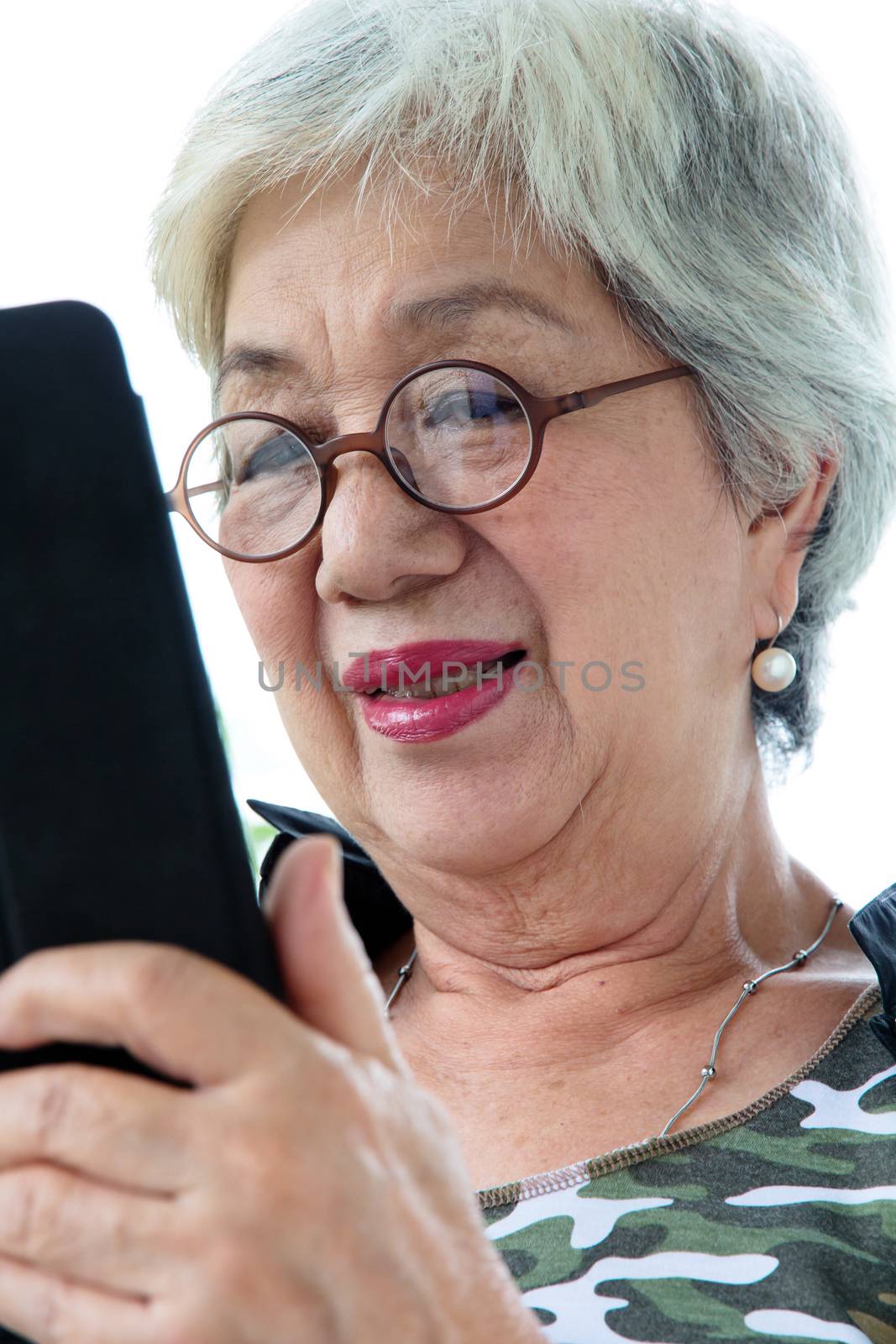 Senior woman with tablet by ponsulak