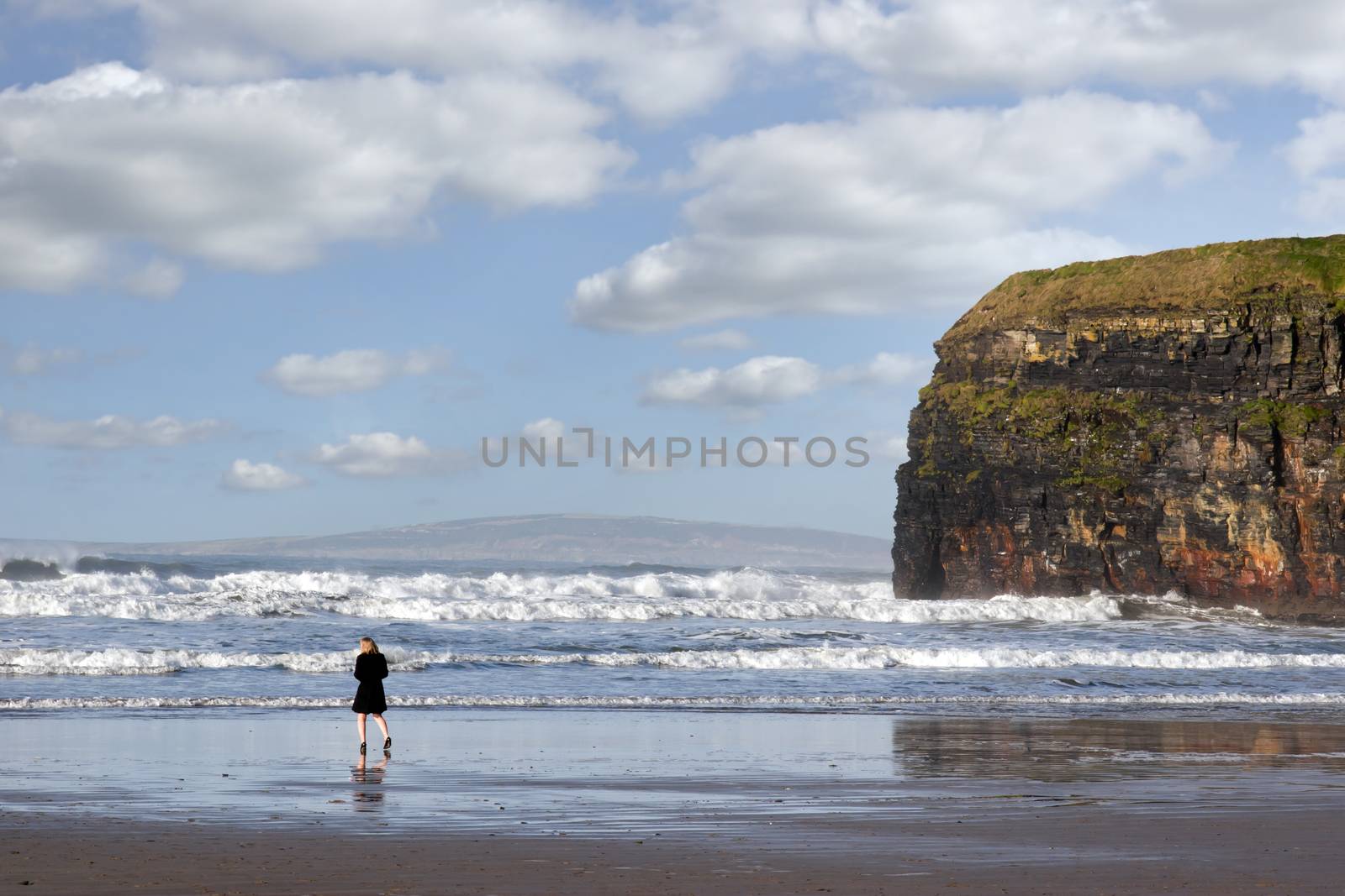 woman in high heels at cliffs of Ballybunion on the wild atlantic way in county Kerry Ireland