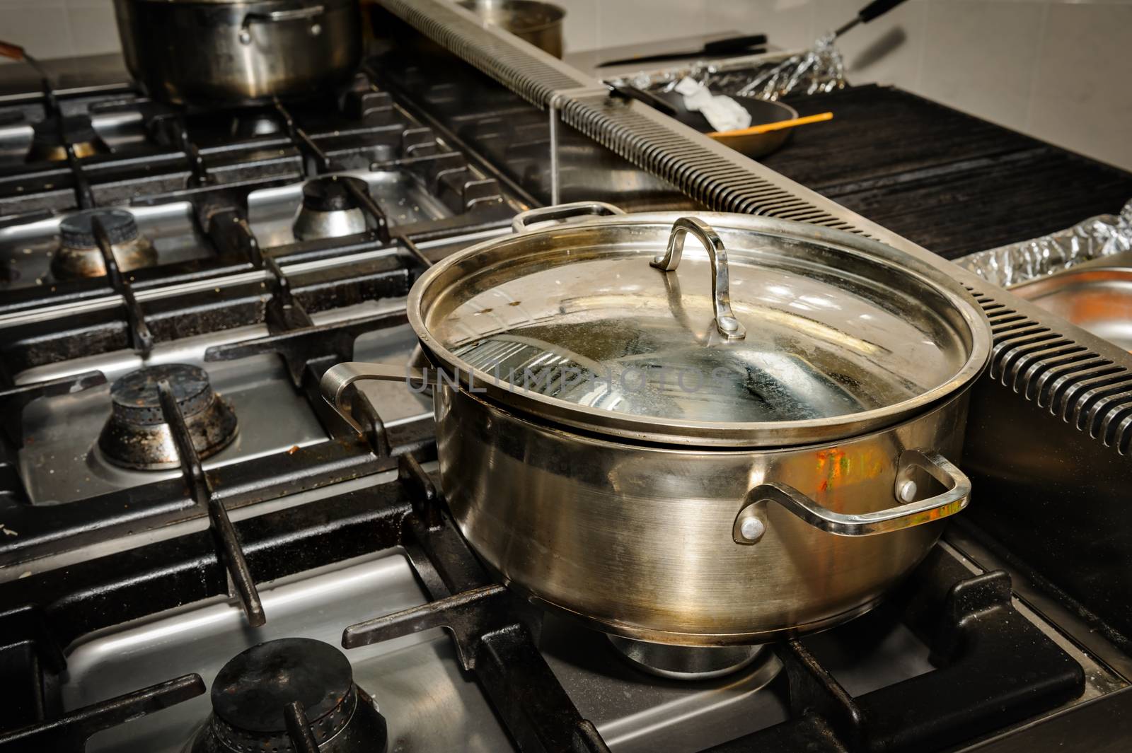real dirty restaurant kitchen, pot on stove