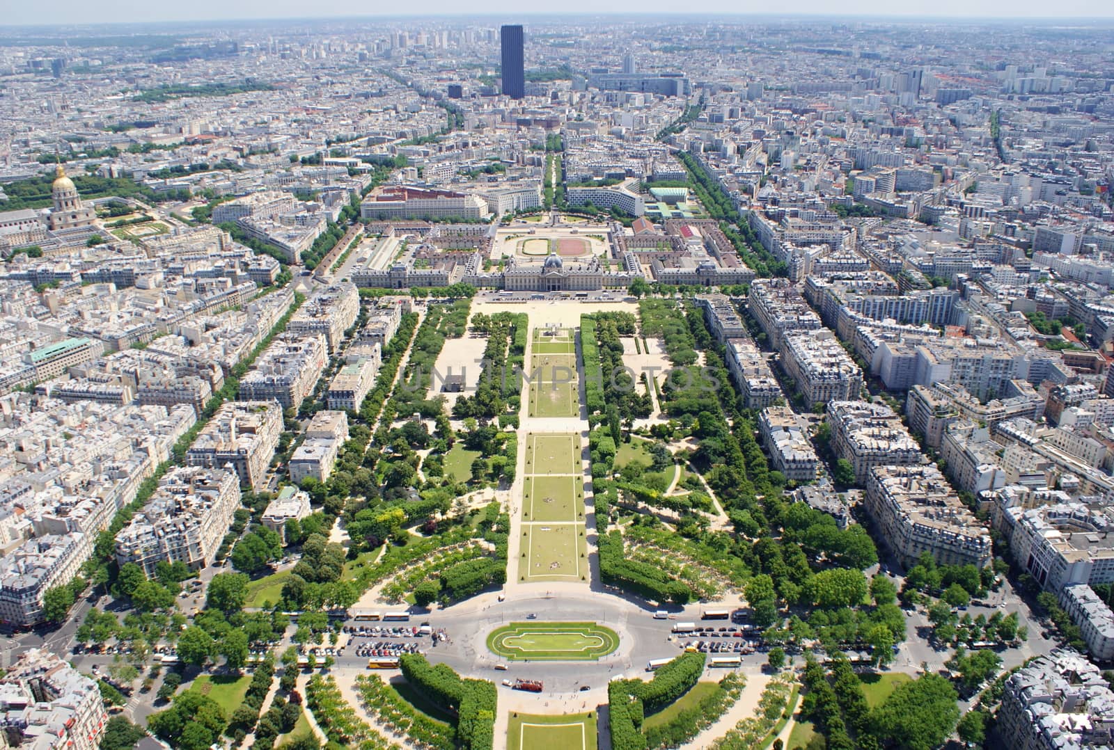 Photo is showing various views onto Paris, France with its many houses and roofs.