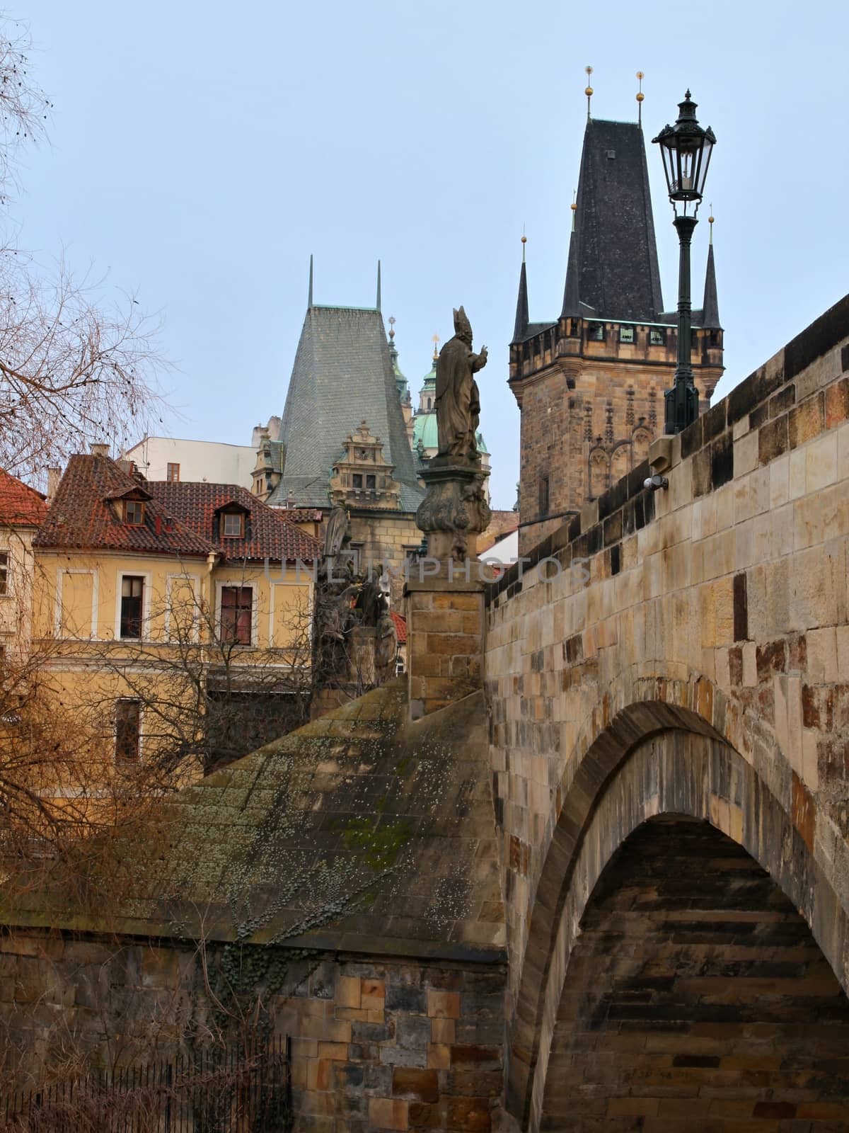 Photo of Charles bridge in Prague, Czech republic with the view onto old houses, towers and Vltava river.
