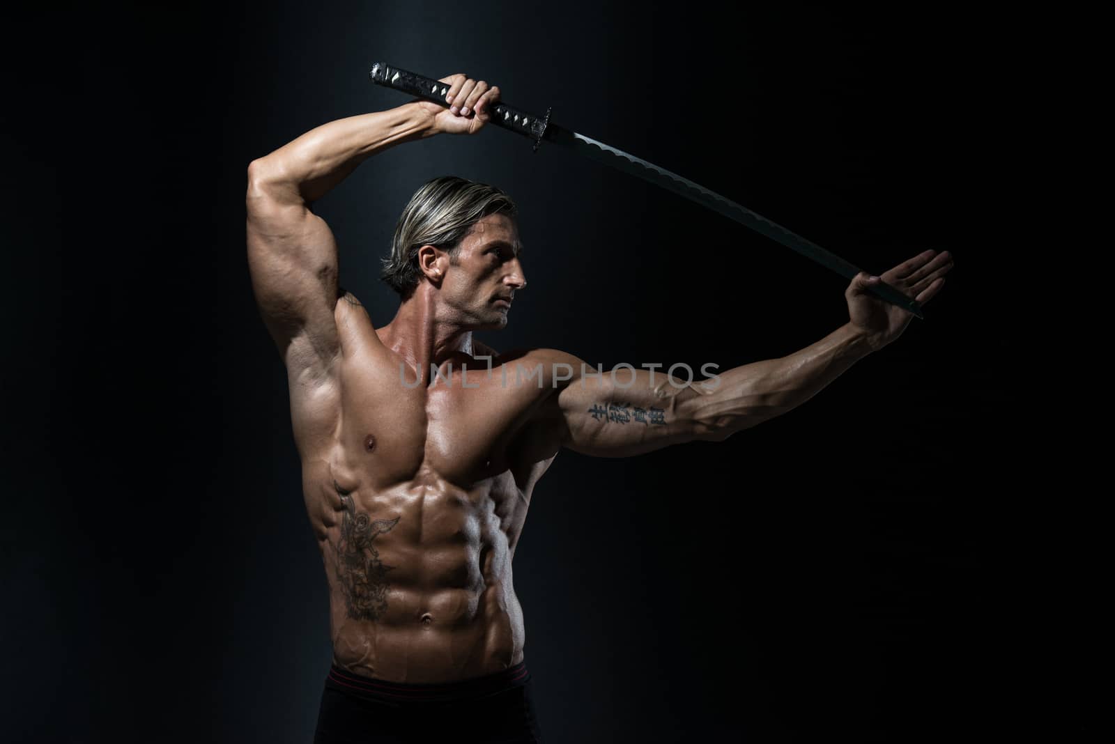 Mature Man Holding Sword Ready To Fight by JalePhoto