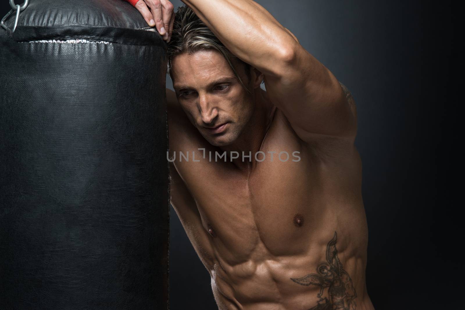 MMA Fighter Practicing With Boxing Bag by JalePhoto