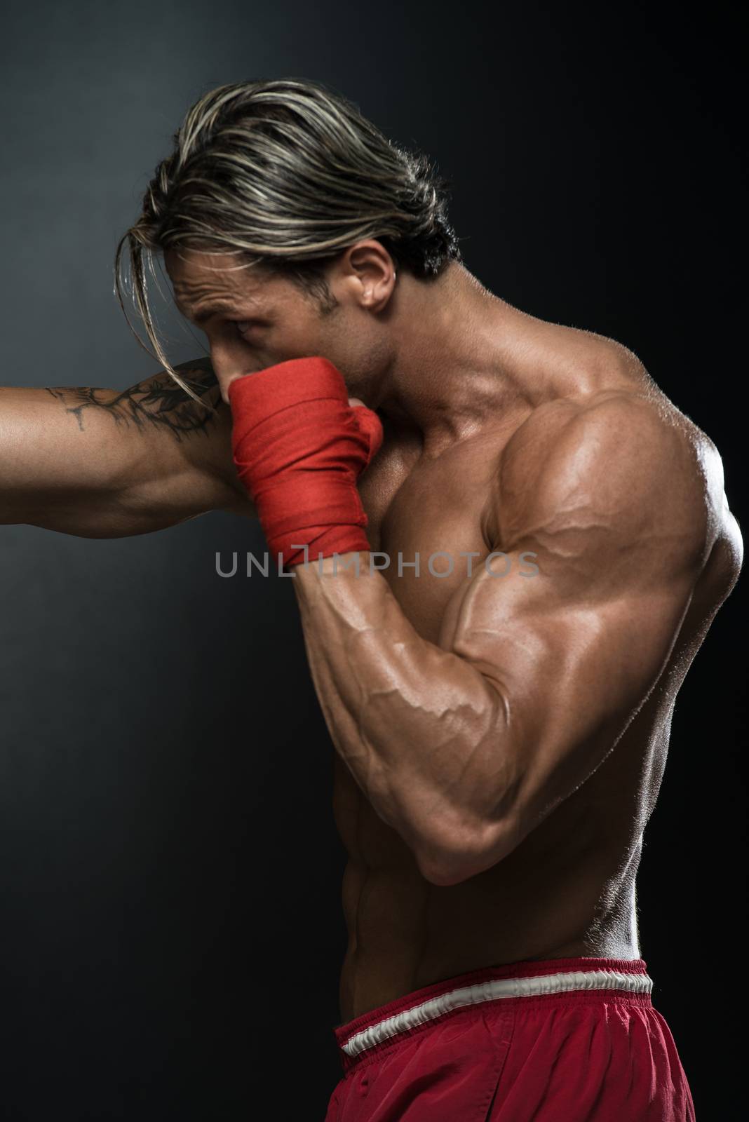 A Man With A Tattoo In Red Boxing Gloves - Boxing On Black Background - The Concept Of A Healthy Lifestyle - The Idea For The Film About Boxing