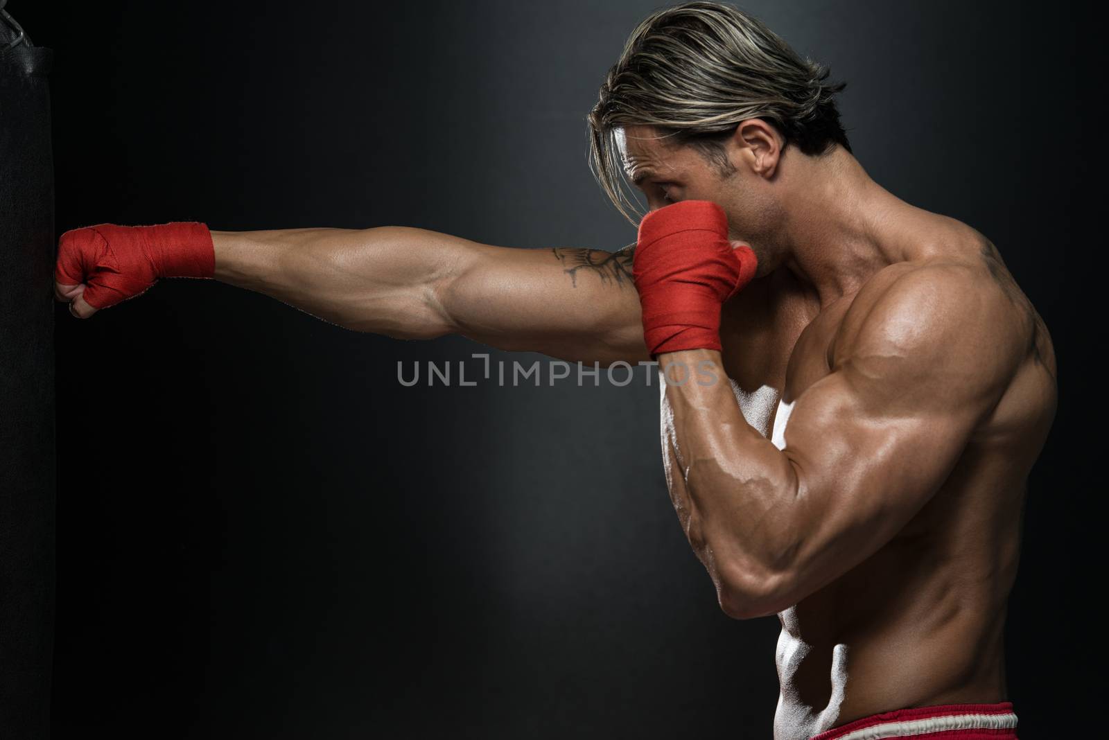 A Man With A Tattoo In Red Boxing Gloves - Boxing On Black Background - The Concept Of A Healthy Lifestyle - The Idea For The Film About Boxing