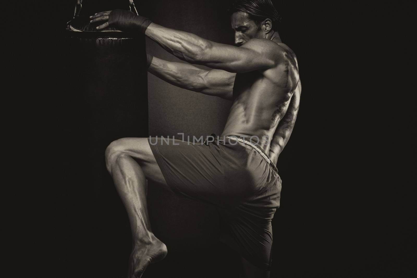 MMA Fighter Practicing Some Kicks With Punching Bag by JalePhoto