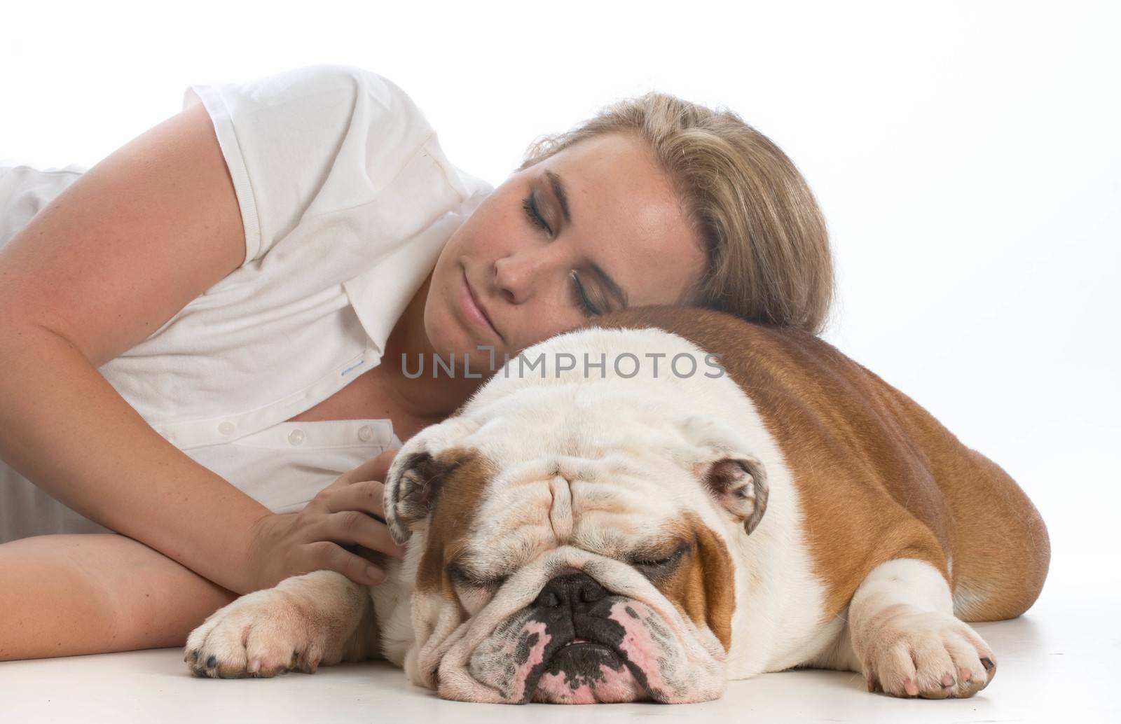 woman resting her head on her english bulldog on white background