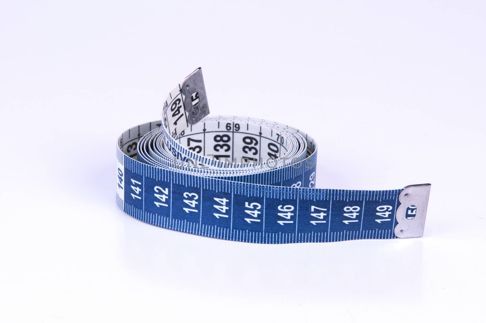 A tape measure or measuring tape is a flexible ruler on white background