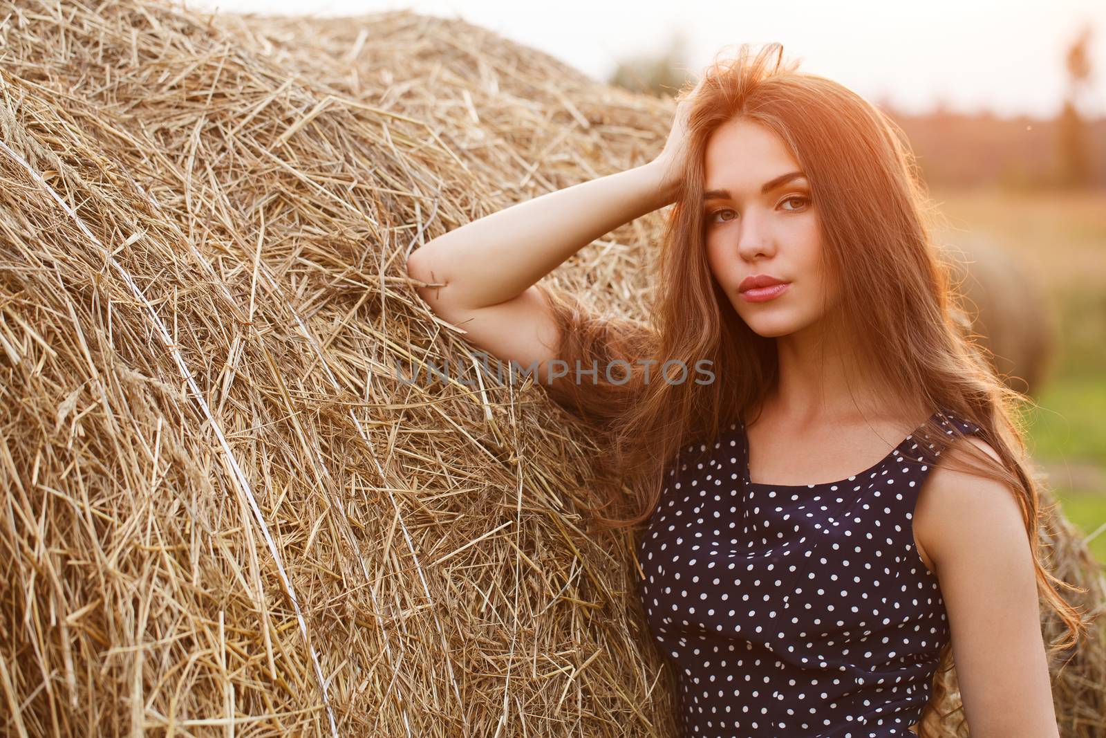 Rural, evening. Beautiful girl in cute dress