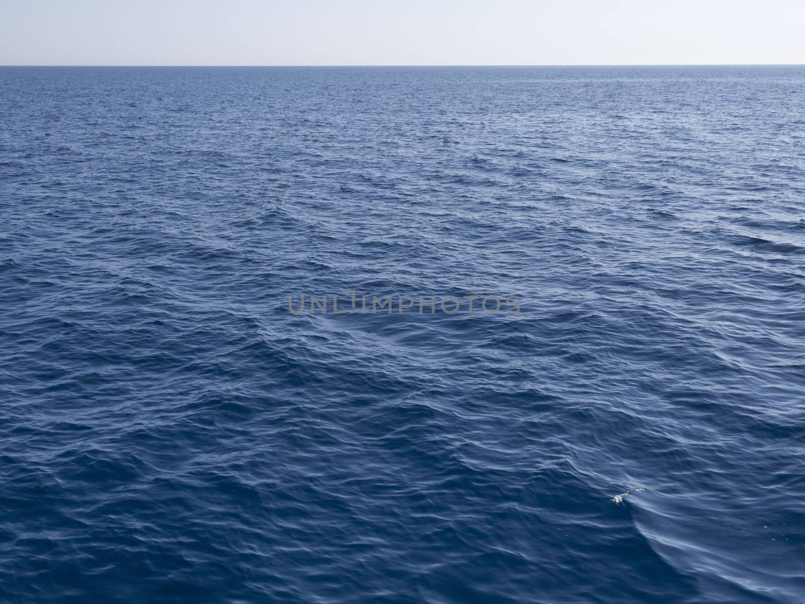 clear blue sea with distant horizon line