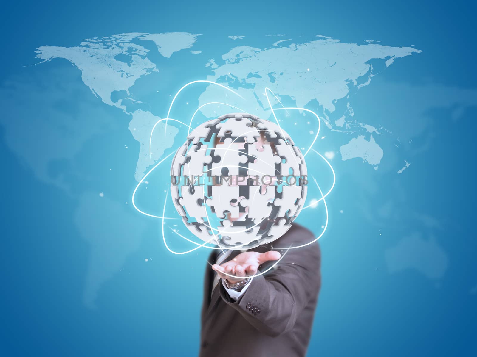 Business man hold exploding ball of gray puzzle pieces in hand. World map as backdrop