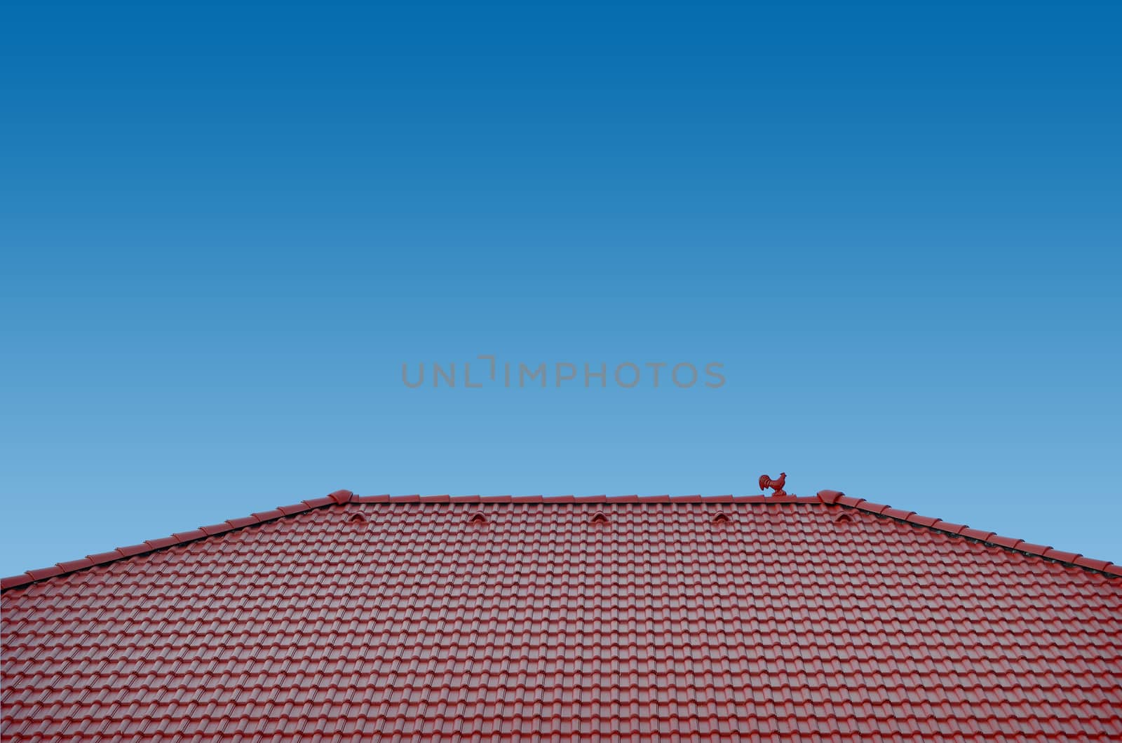 roof with brown tiles on a background of blue sky, new roof