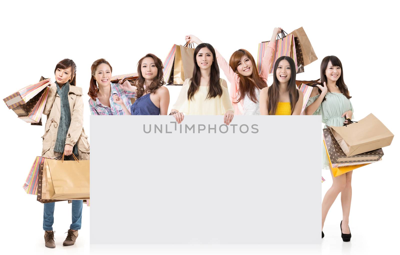 Attractive Asian woman shopping and one lady holding blank board, full length portrait isolated on white background.