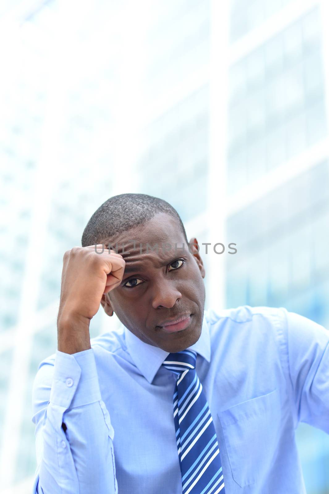 Businessman in depression with hand on forehead