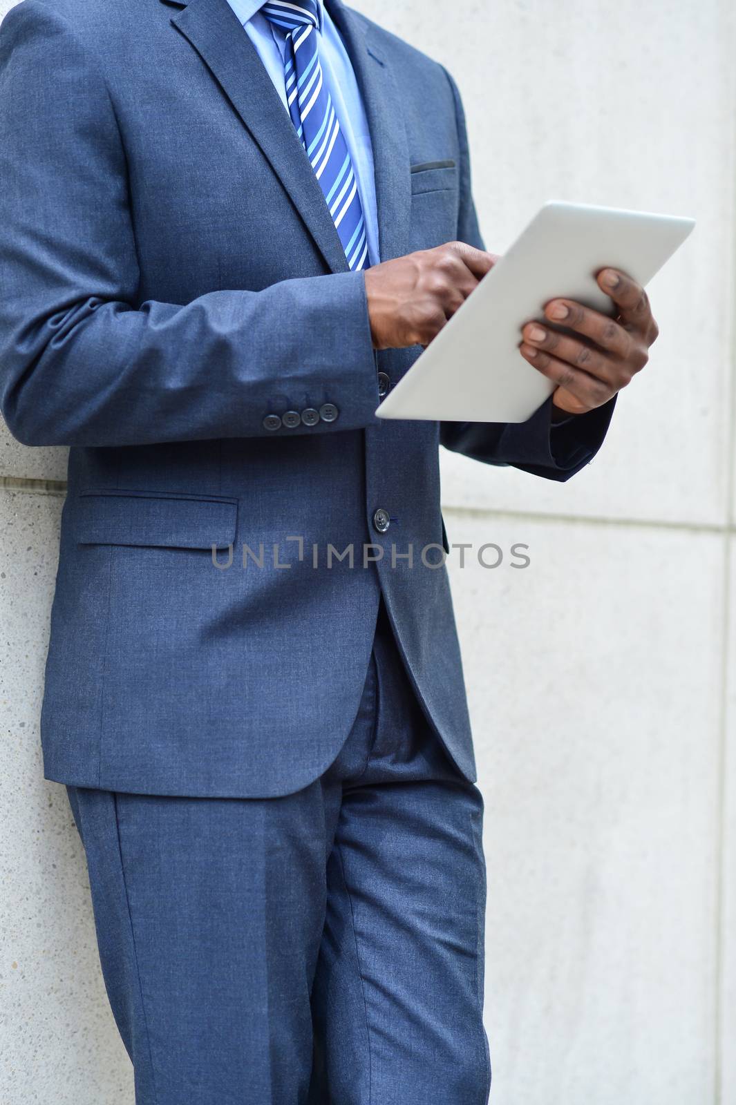 Hands of the businessman using a tablet PC by stockyimages