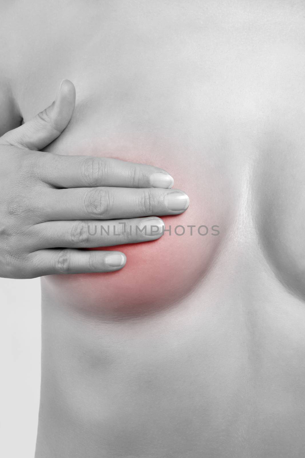 Breast cancer. Female hand touching naked breast isolated on white background. Black and white picture with red pain area. Feminine health concept.
