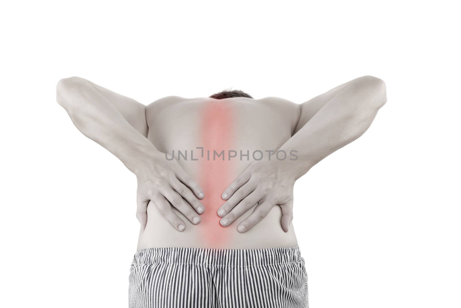 Back Pain. Handsome young man touching his sore back with highlighted area isolated on white background.