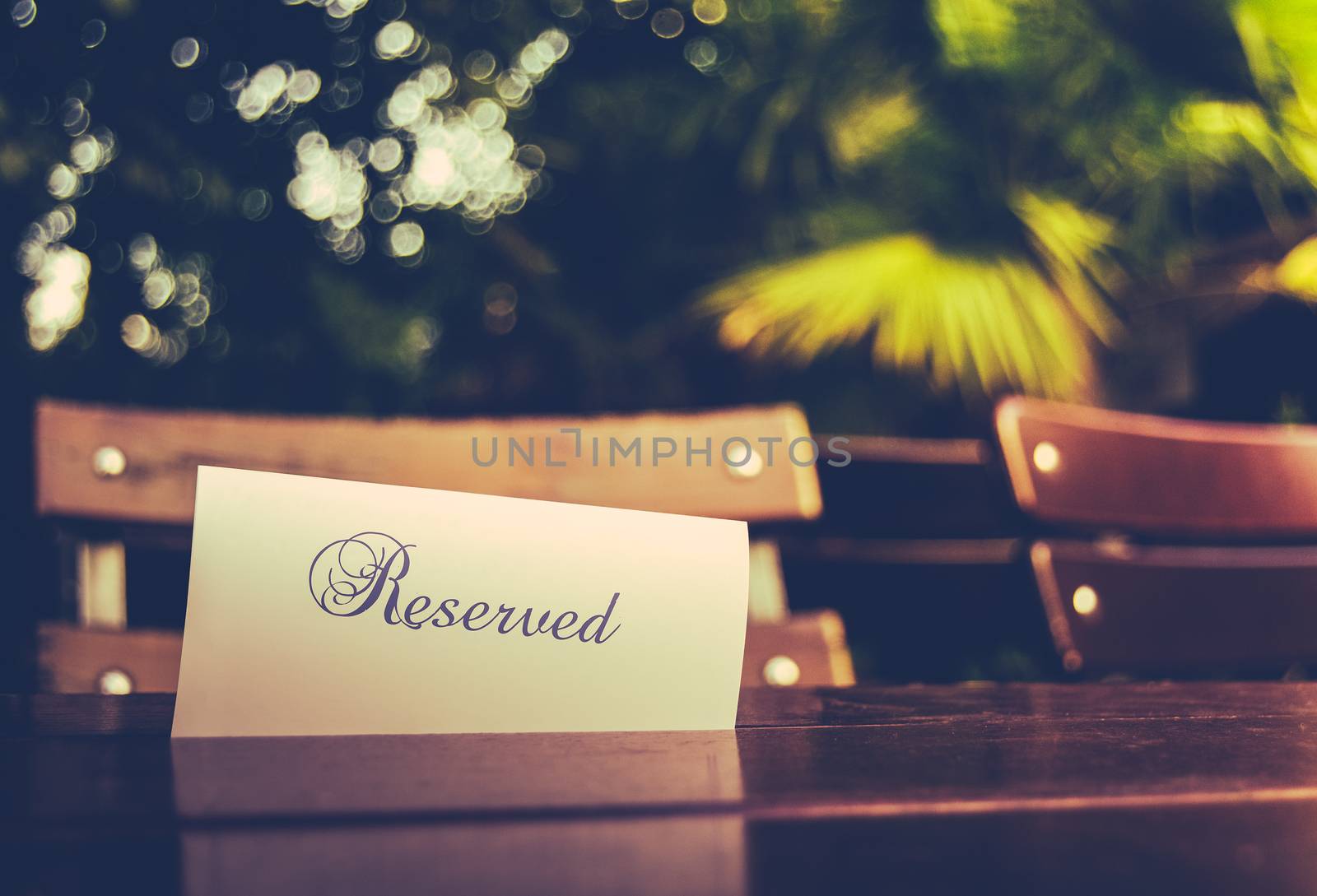 Vintage Styled Image Of A Reserved Sign On A Table At An Outdoor Restaurant