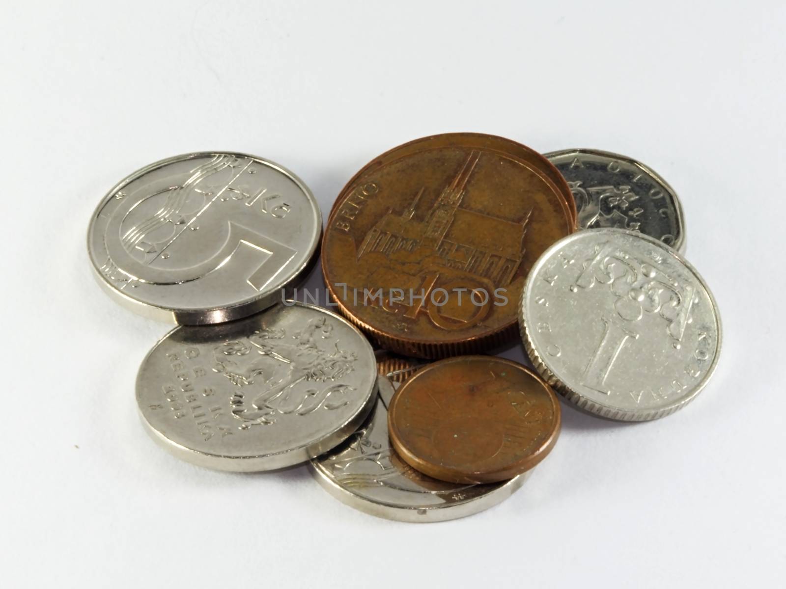 Photo presents details of coins set on the white background.