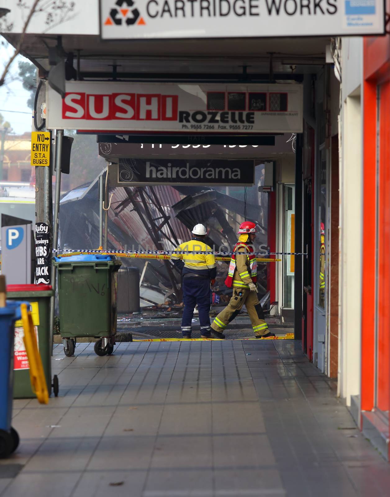 ROZELLE, AUSTRALIA - SEPTEMBER 4, 2014;   Fire search and rescue teams begin the search in the remains of rubble for three missing people after an explosion in a convenience store in Darling Street, Rozelle, Sydney, Australia.  Police are treating the explosion as suspicious