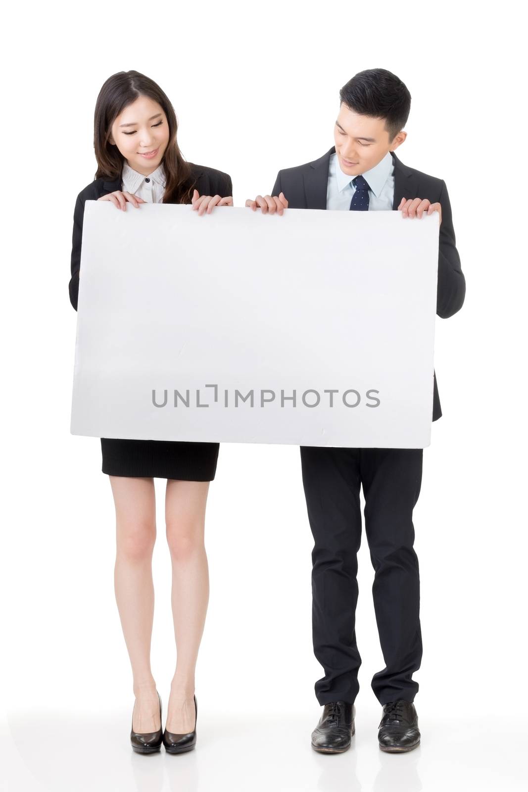 Business man and woman holding blank white board by elwynn