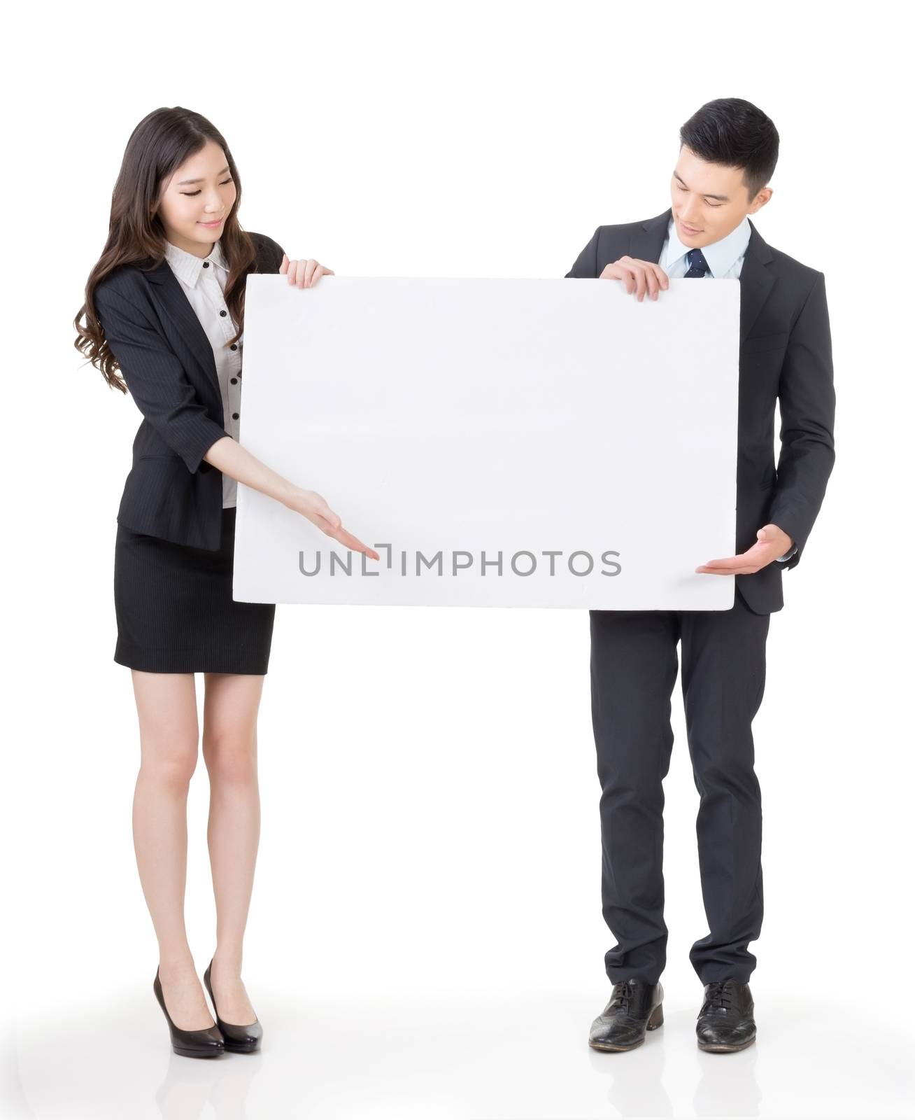 Business man and woman holding blank white board, full length portrait isolated on white background.