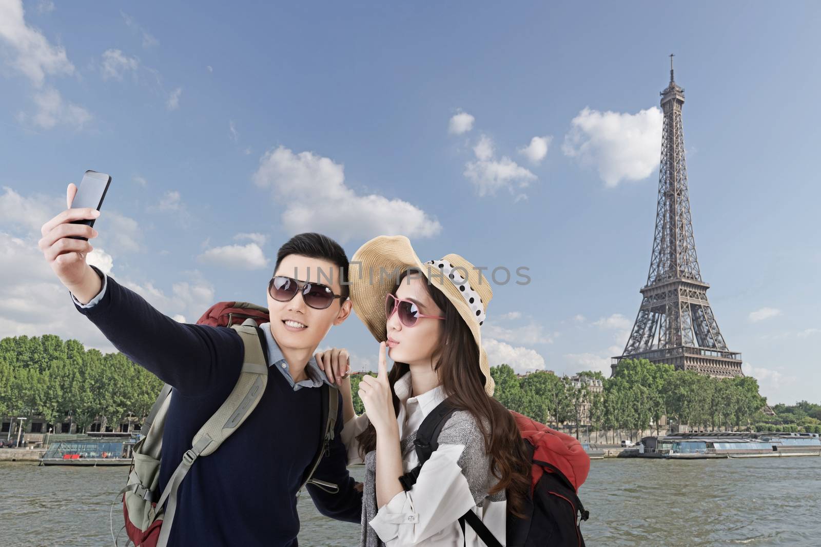 Asian couple travel and selfie in Paris, France.