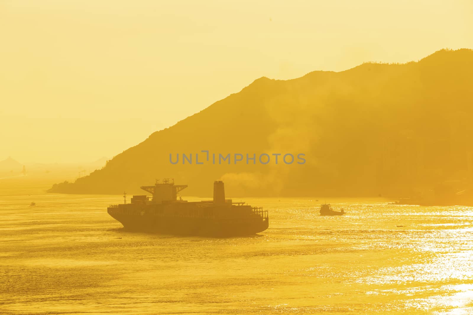 Cargo ship under sunset