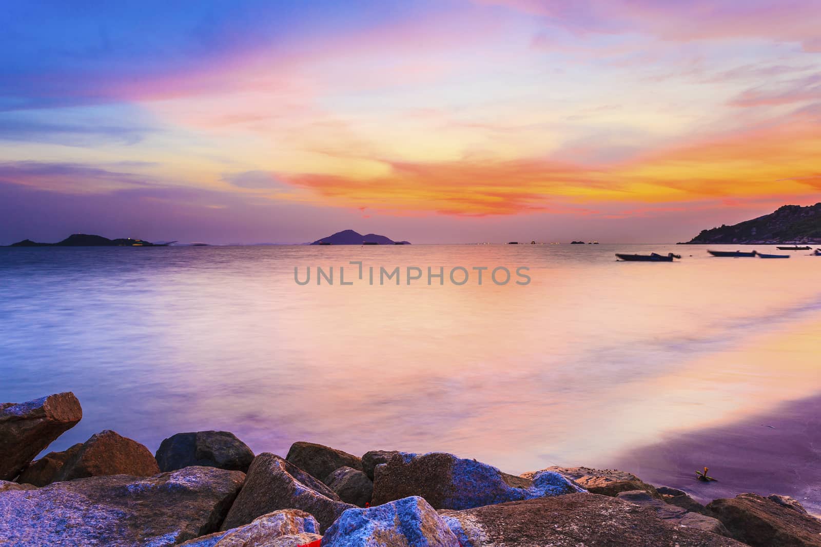 Sunset at the seashore with sea stones background