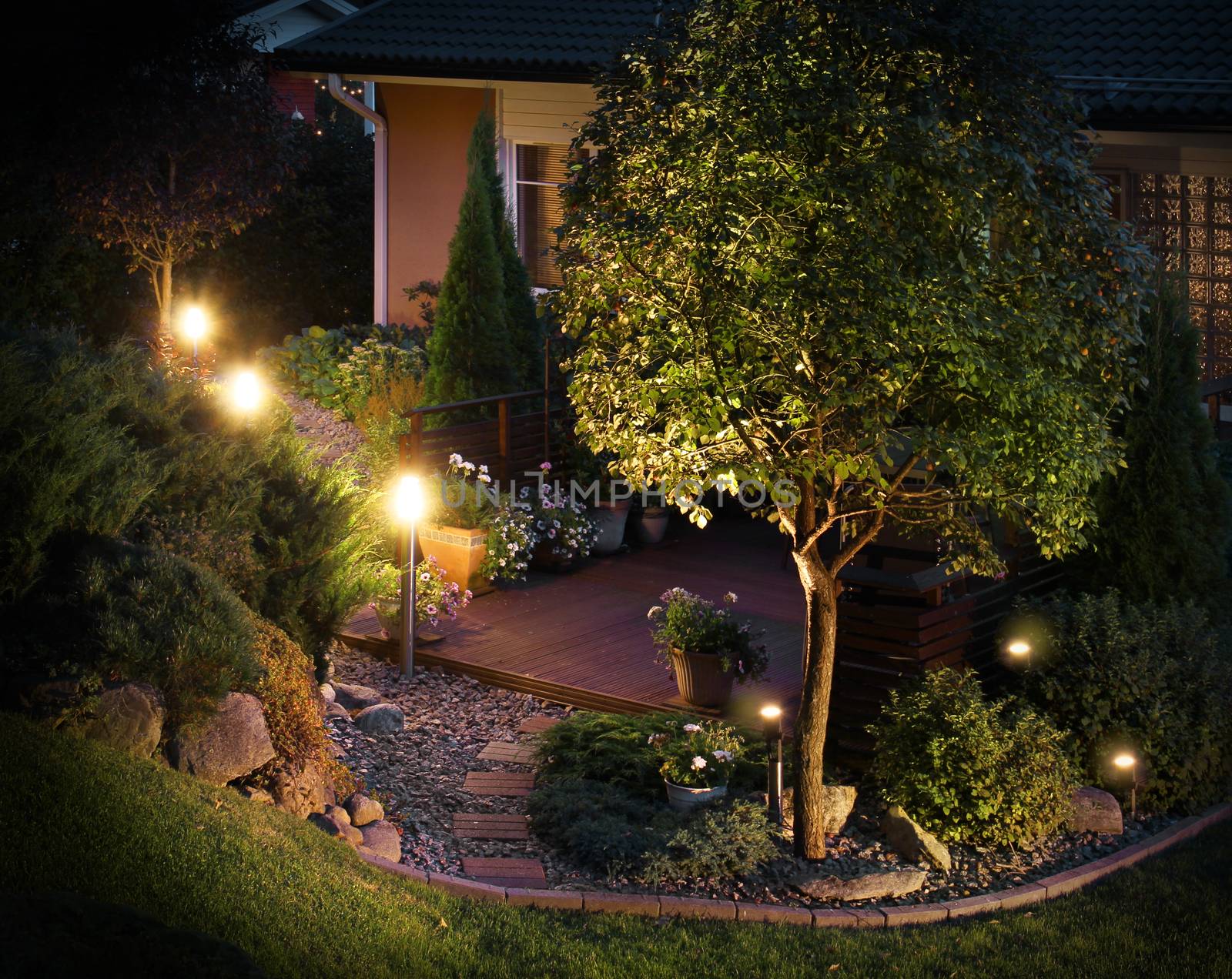 Illuminated home garden path patio lights in evening dusk
