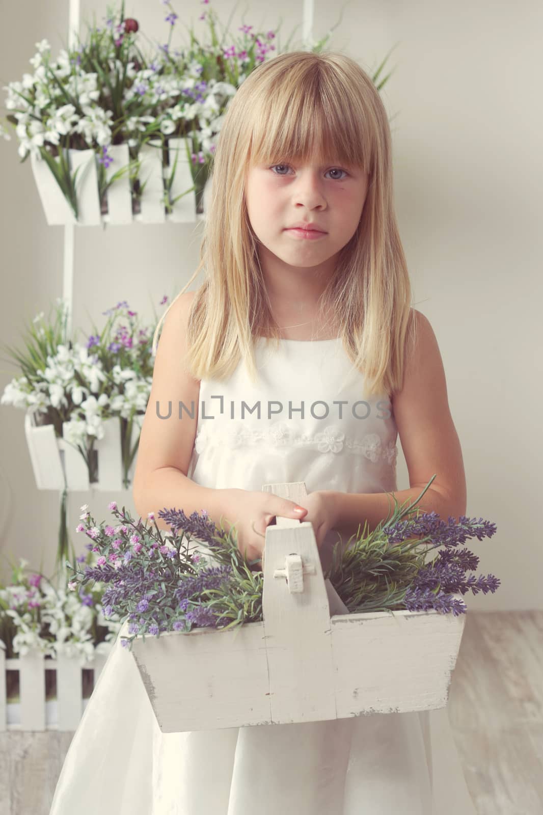 beautiful girl with summer flowers in the garden center
