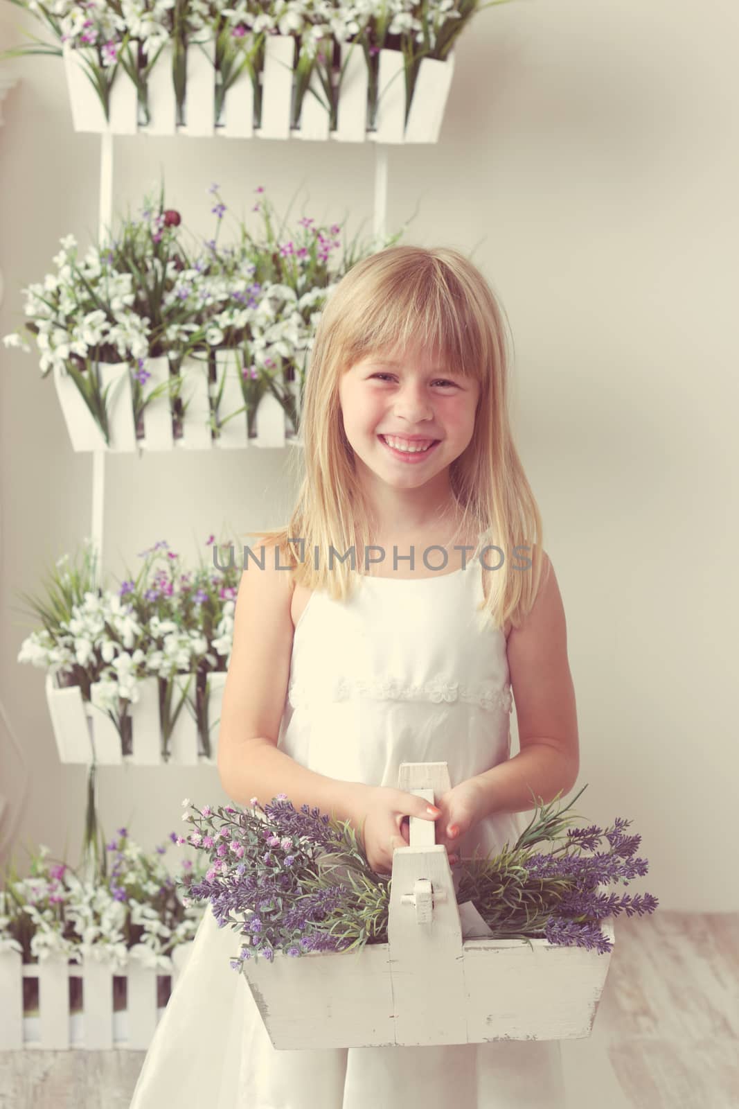 beautiful girl with summer flowers in the garden center