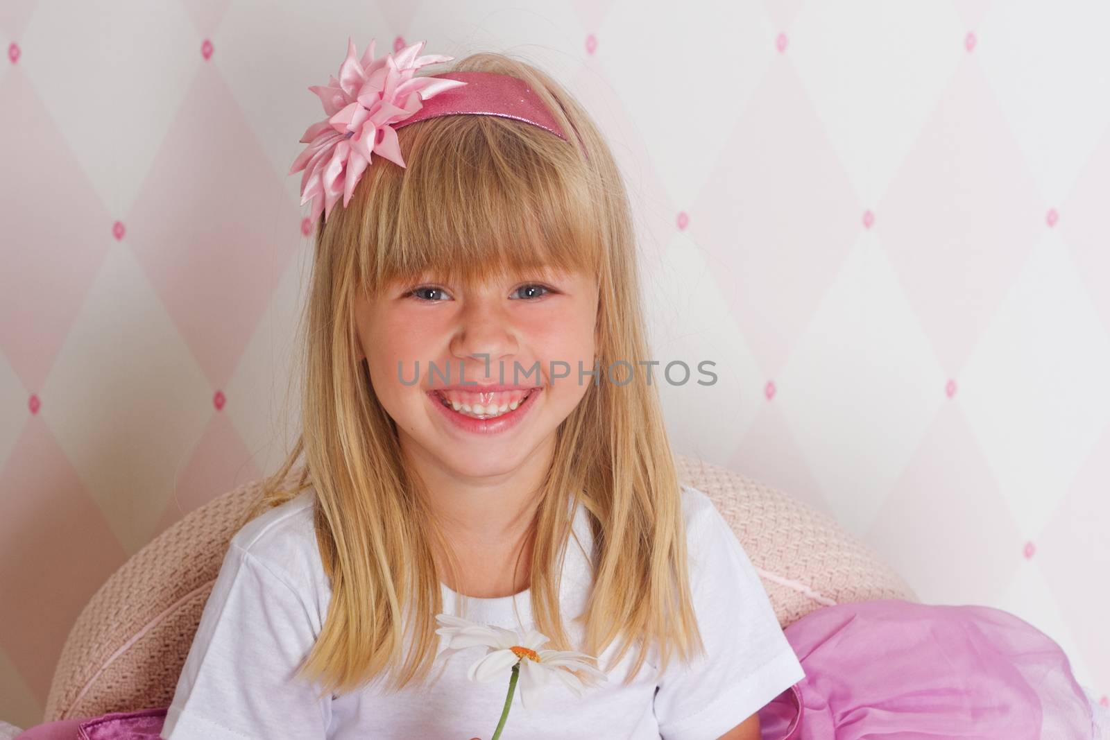 Little girl princess is sitting on chair