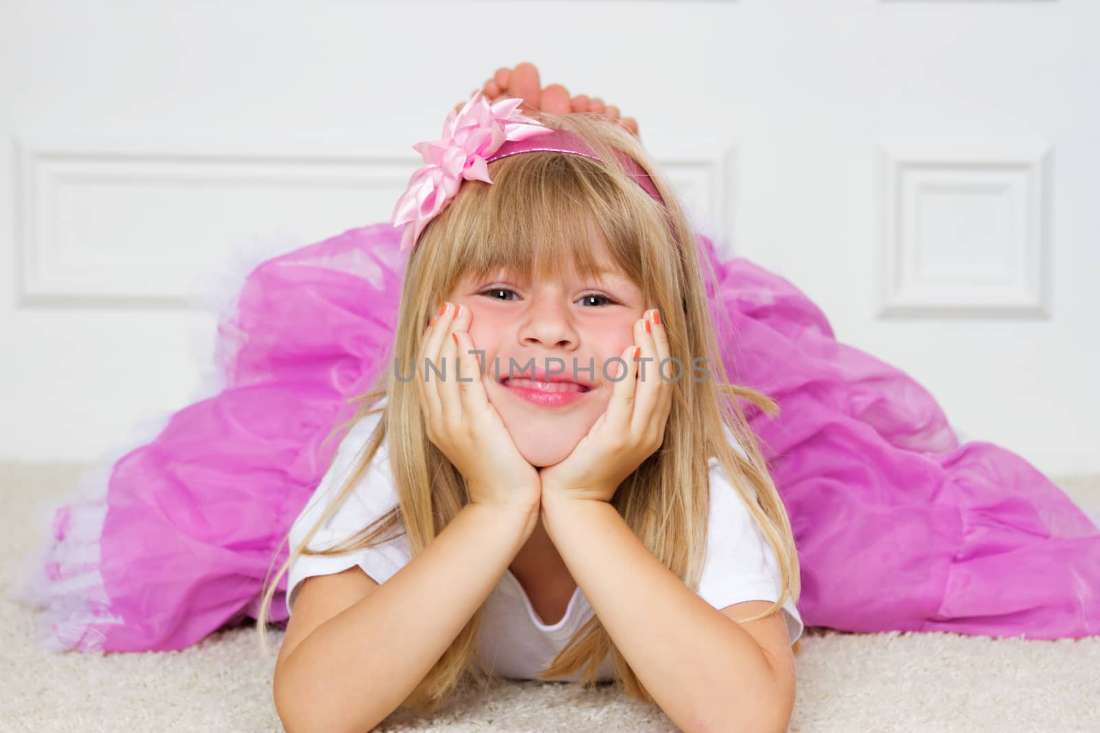 Beautiful girl lying on floor studio shot