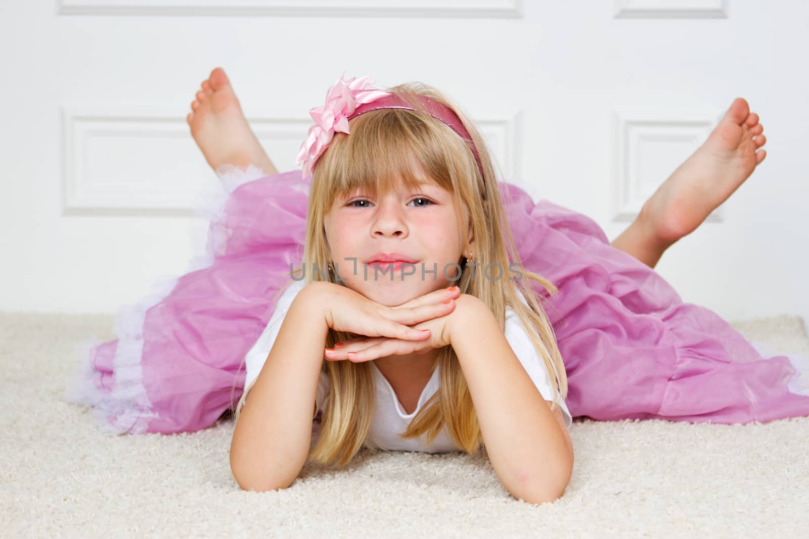 Beautiful girl lying on floor studio shot