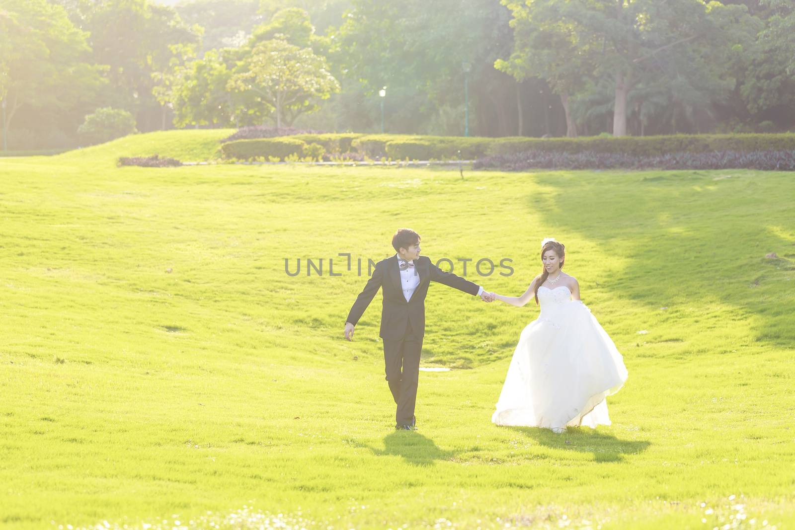 Bride and groom walking by kawing921