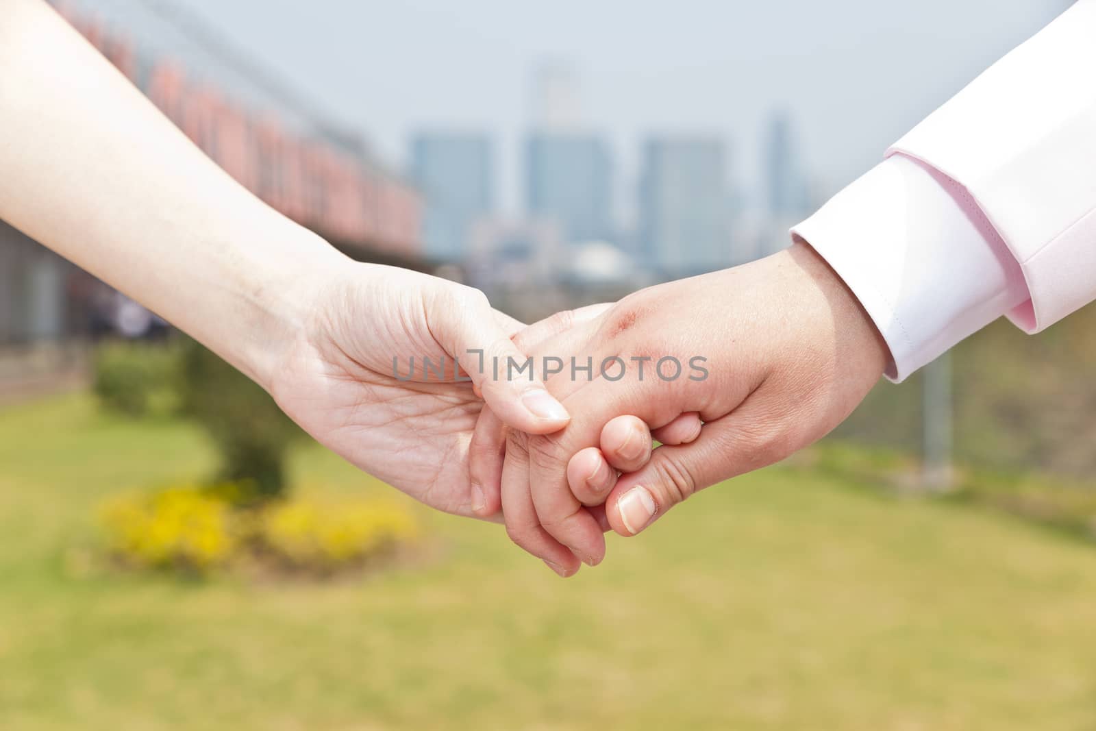 Close-up of couple holding hands by kawing921