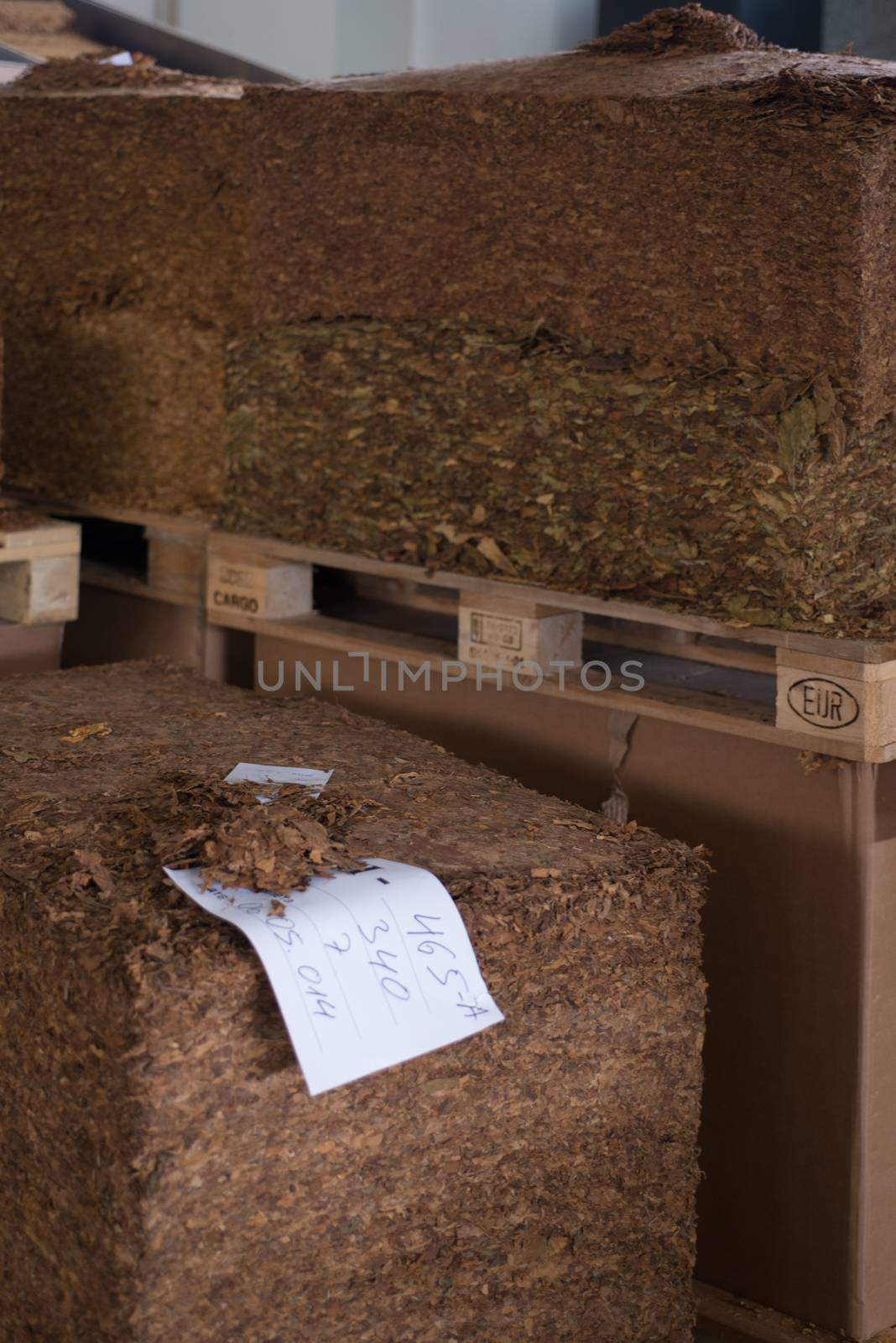 Bulk tobacco palettes inside a cigarette factory warehouse