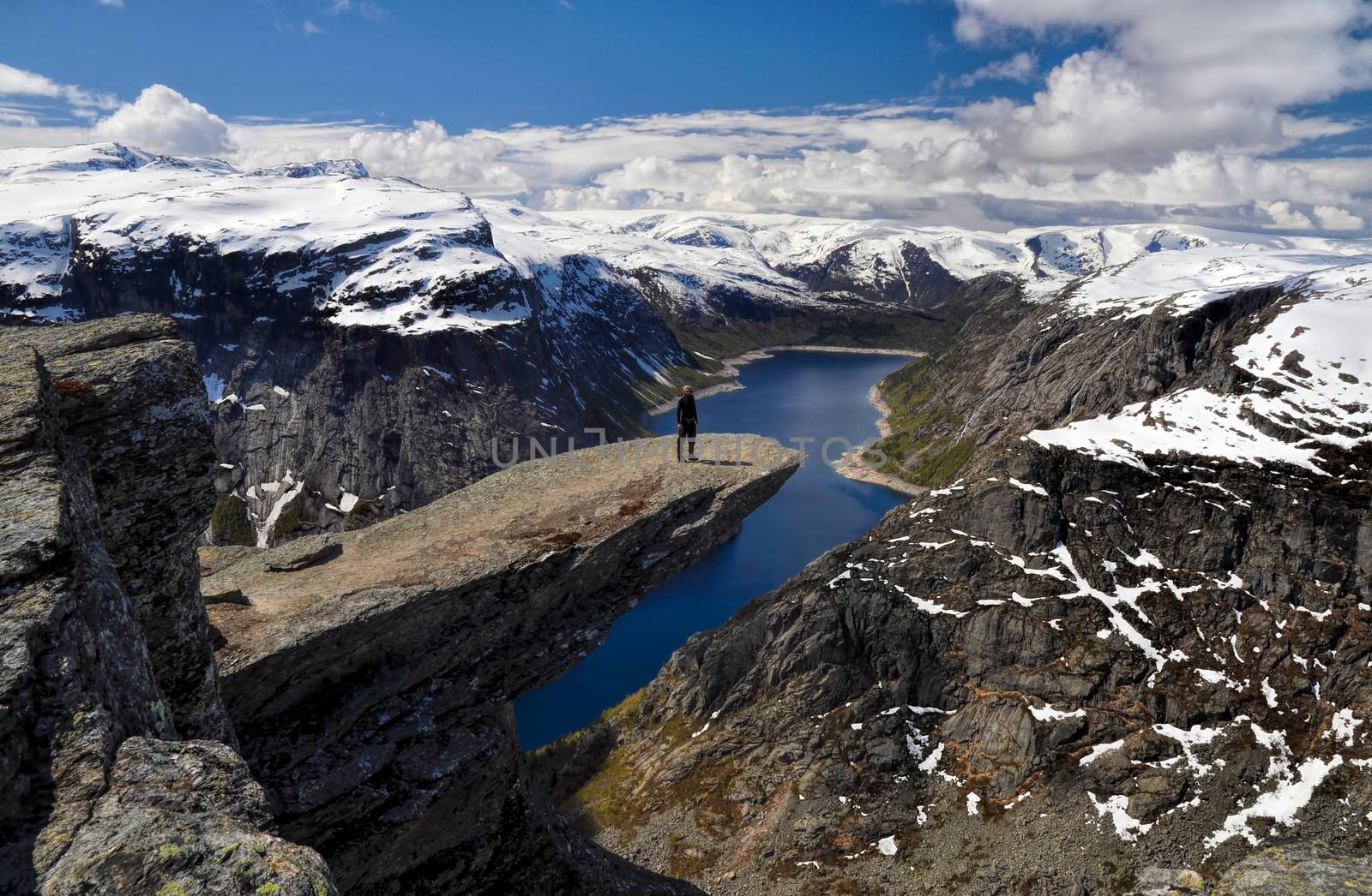 Hiker on Trolltunga, Norway by MichalKnitl