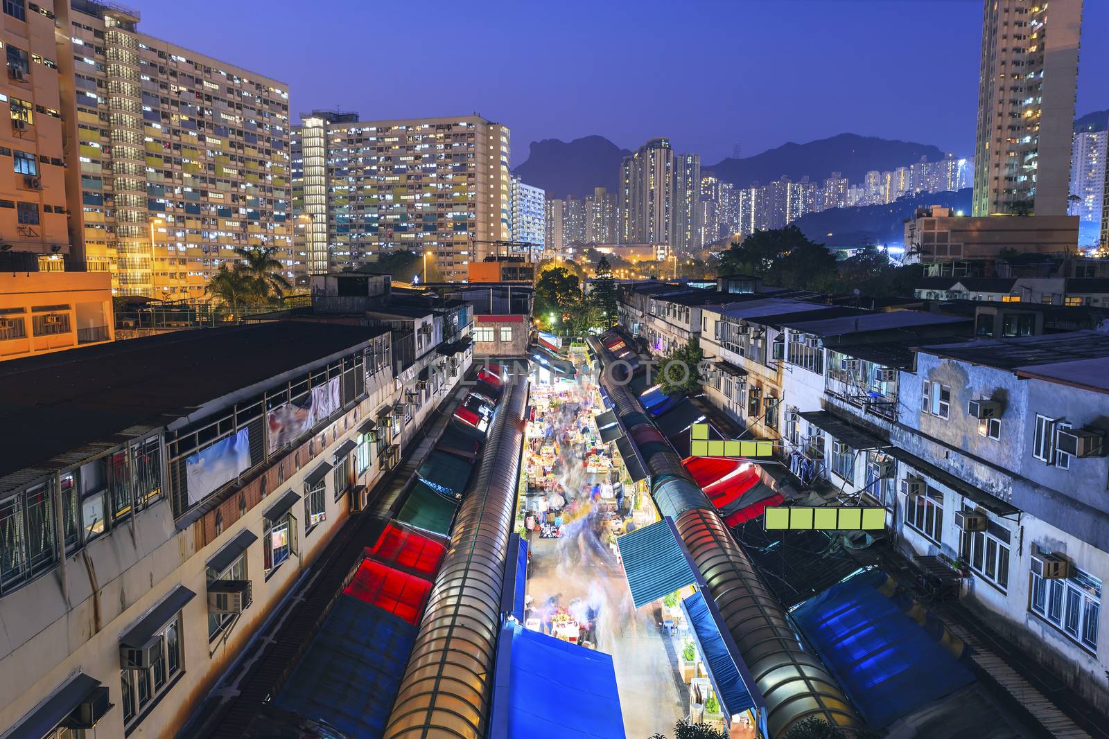 Hong Kong old market with housings at night by kawing921