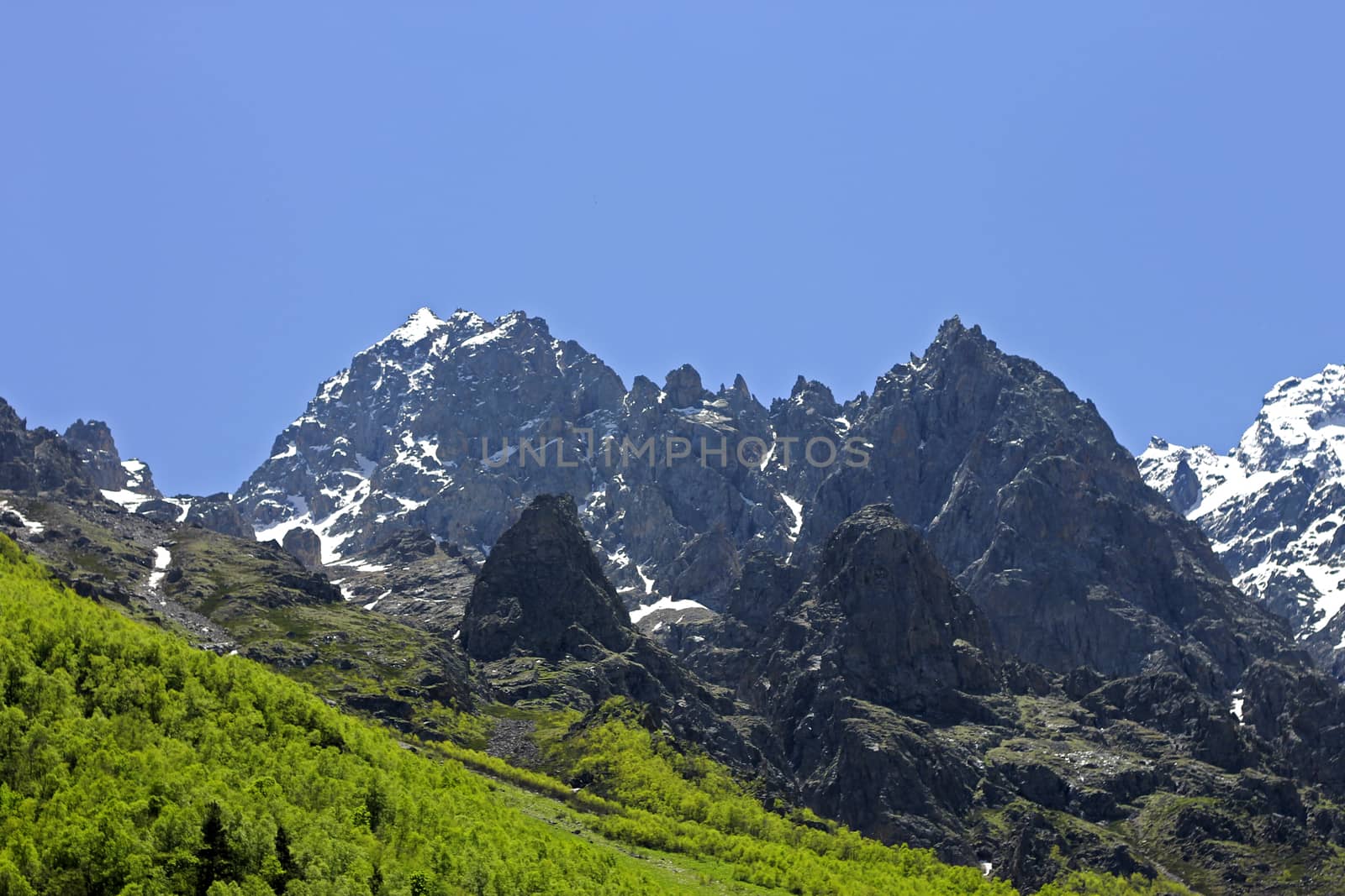 Caucasus mountains under snow and clear blue sky