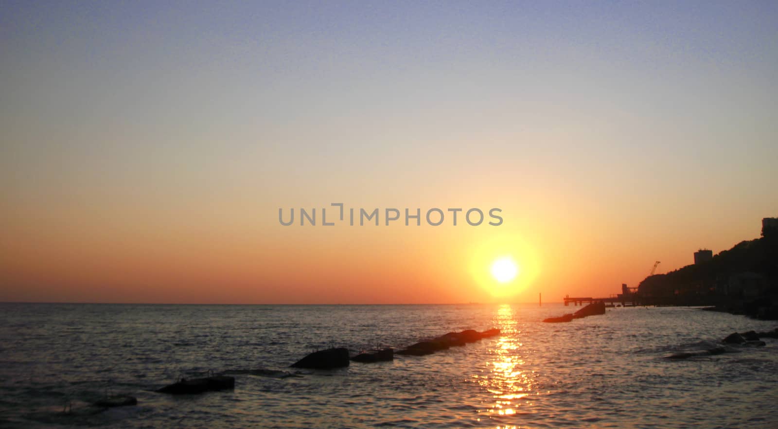 Sunset over summer sea with a small waves