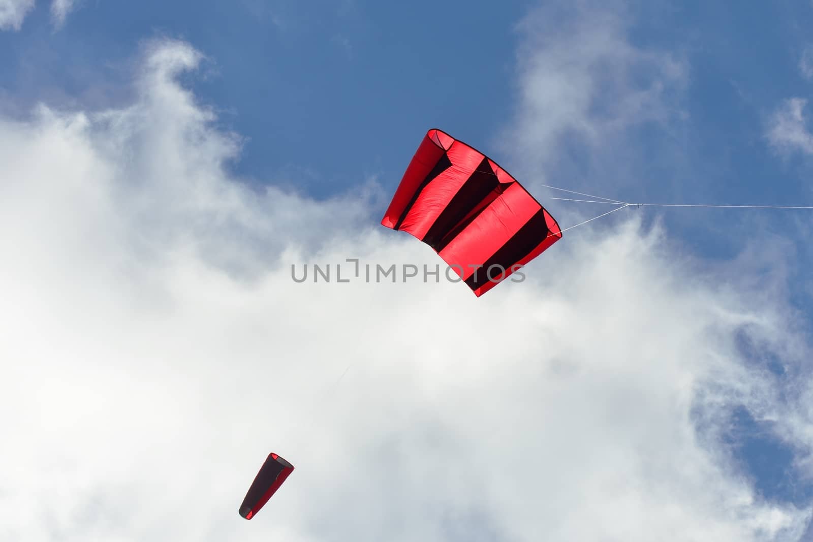 Red and black kite in sky by pauws99