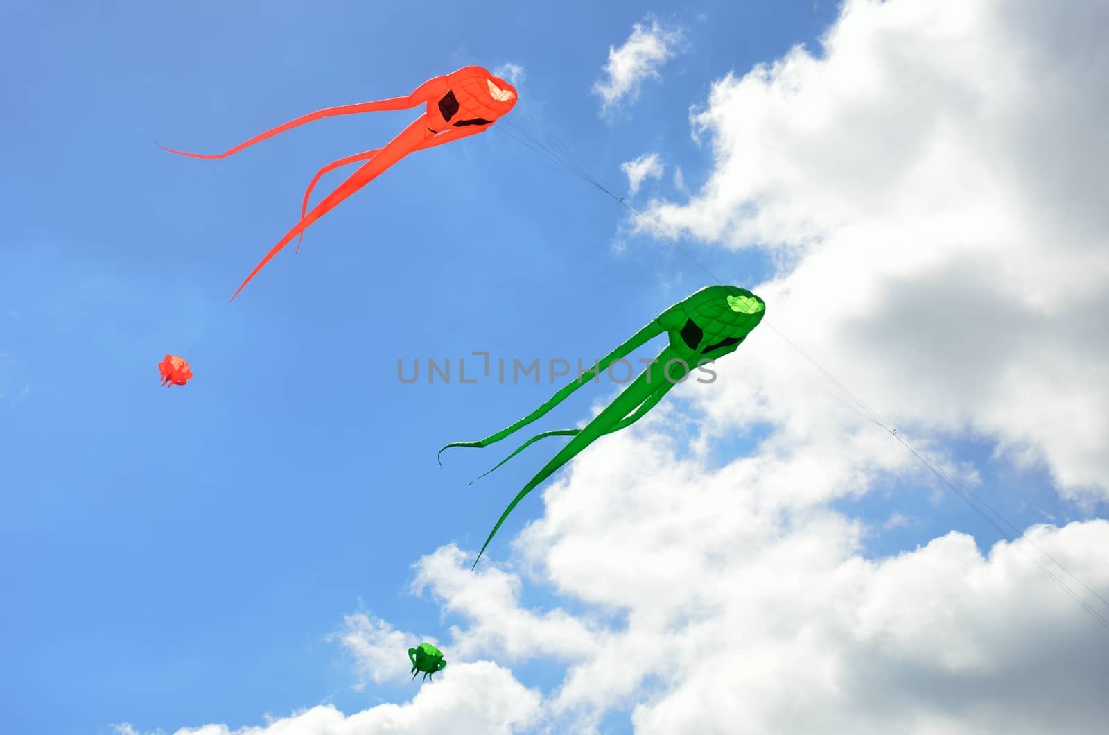 Orange and green space invader kites