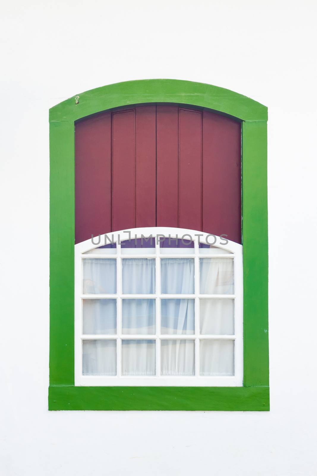 Decorative, colonial, green, vintage, window on a white wall in Paraty (or Parati), Brazil.